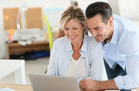 Ehepaar liest am Laptop